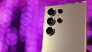 Close up of Samsung Galaxy S24 Ultra cameras with purple lights blurred in the background