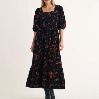 A model wears a Nobody's Child Cord Floral Midi Dress with boots against a light background