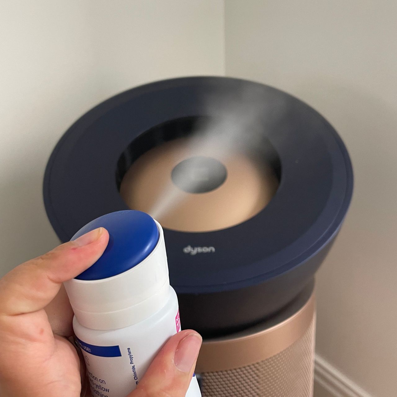 Spraying deodorant in front of the Big+Quiet air purifier