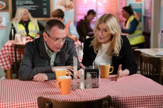 Ian Beale and Cindy go over their business plan