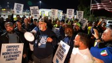 Harold Daggett, president of the International Longshoremen's Association, rallies union members as they begin strike