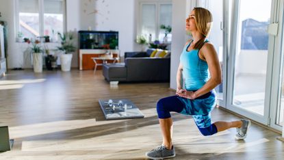 Woman doing a lunge at home.