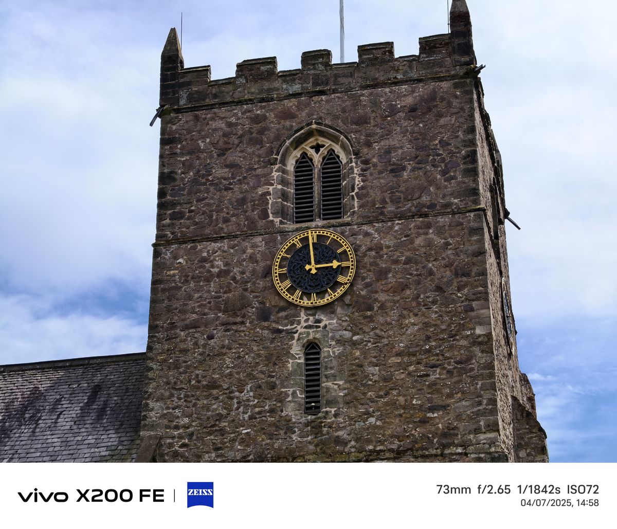 Church spire in front of a blue sky