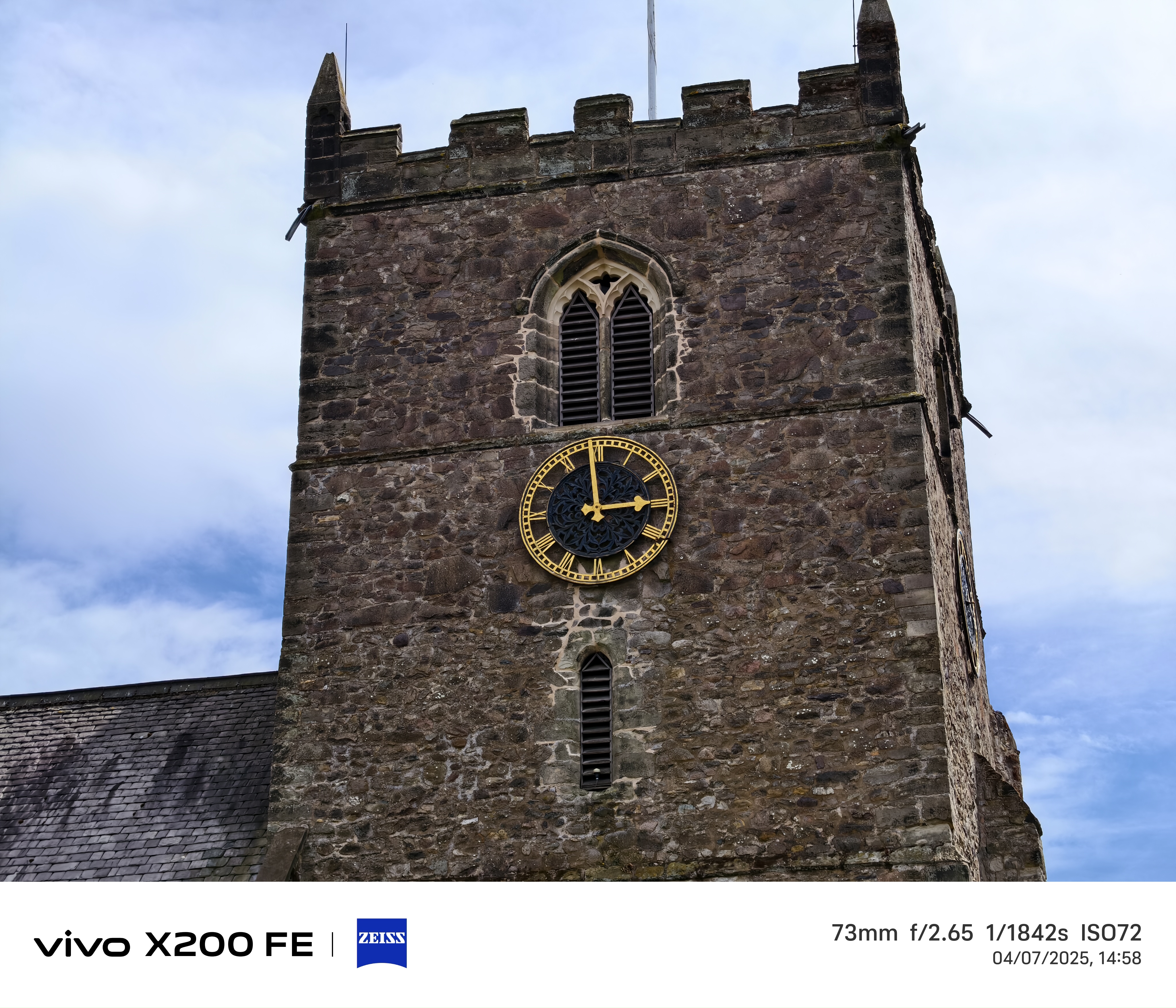 Church spire in front of a blue sky