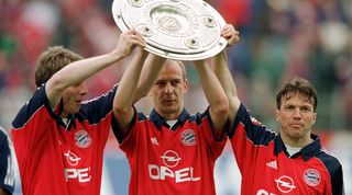 Michael Tarnat, Mario Basler and Lothar Matthaus celebrate with the Bundesliga trophy, 1999