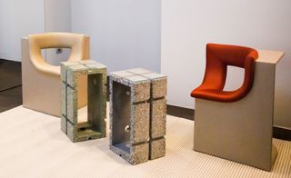 Chairs carved out of squares and coffee tables with glass tops made out of concrete blocks.