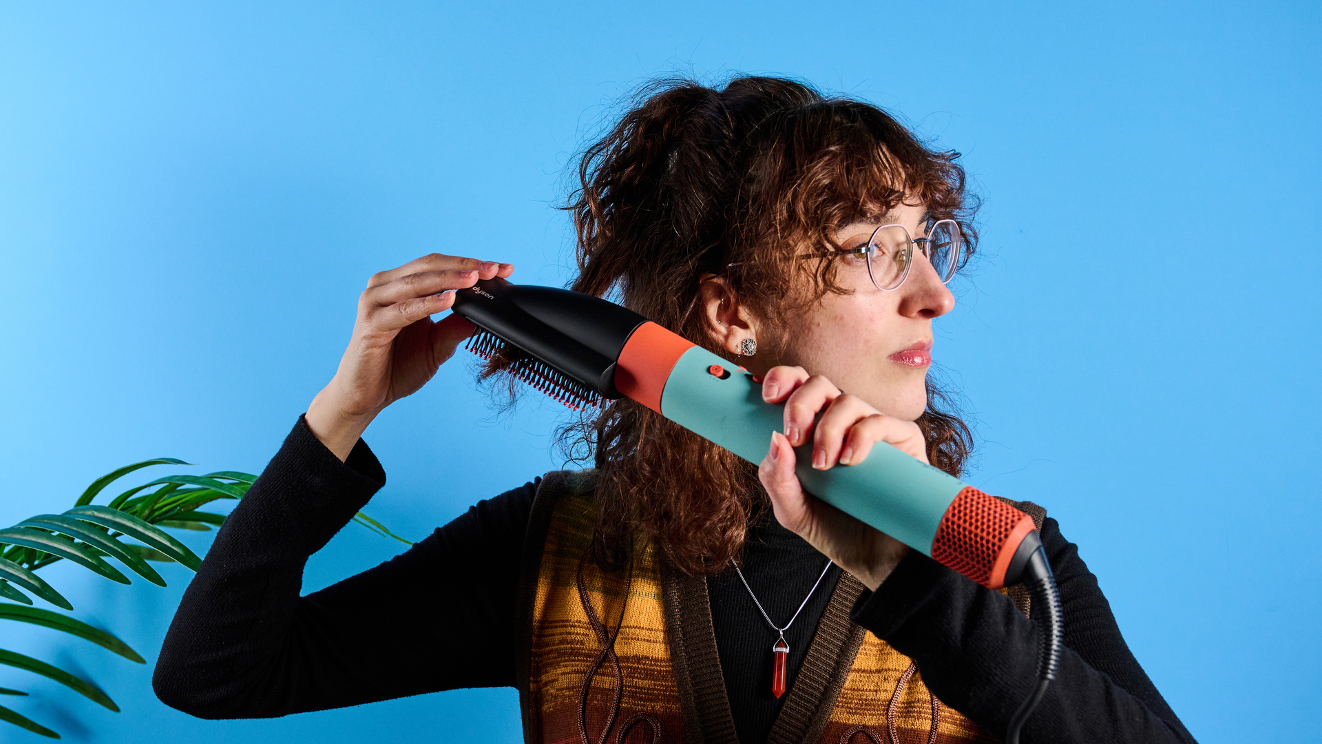 the dyson airwrap ID in teal and terracotta colorway (patina and orange) with a lapis case, with a brush, hairfryer, curling wand attachments