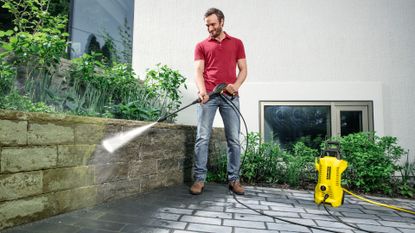 Karcher K2 Power Control man cleaning patio