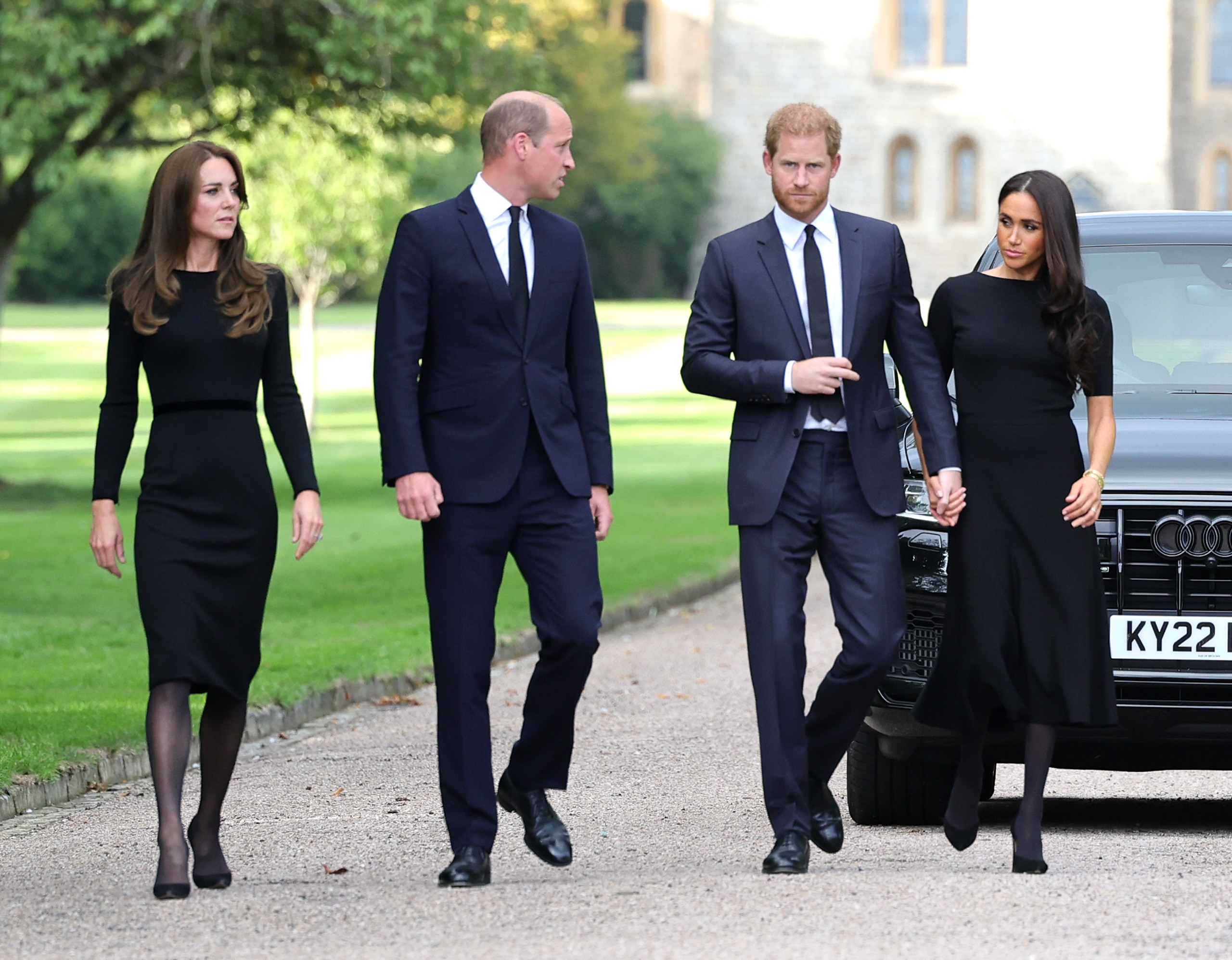 Princess Kate, Prince William, Prince harry and Meghan Markle walking in a row at Windsor Castle