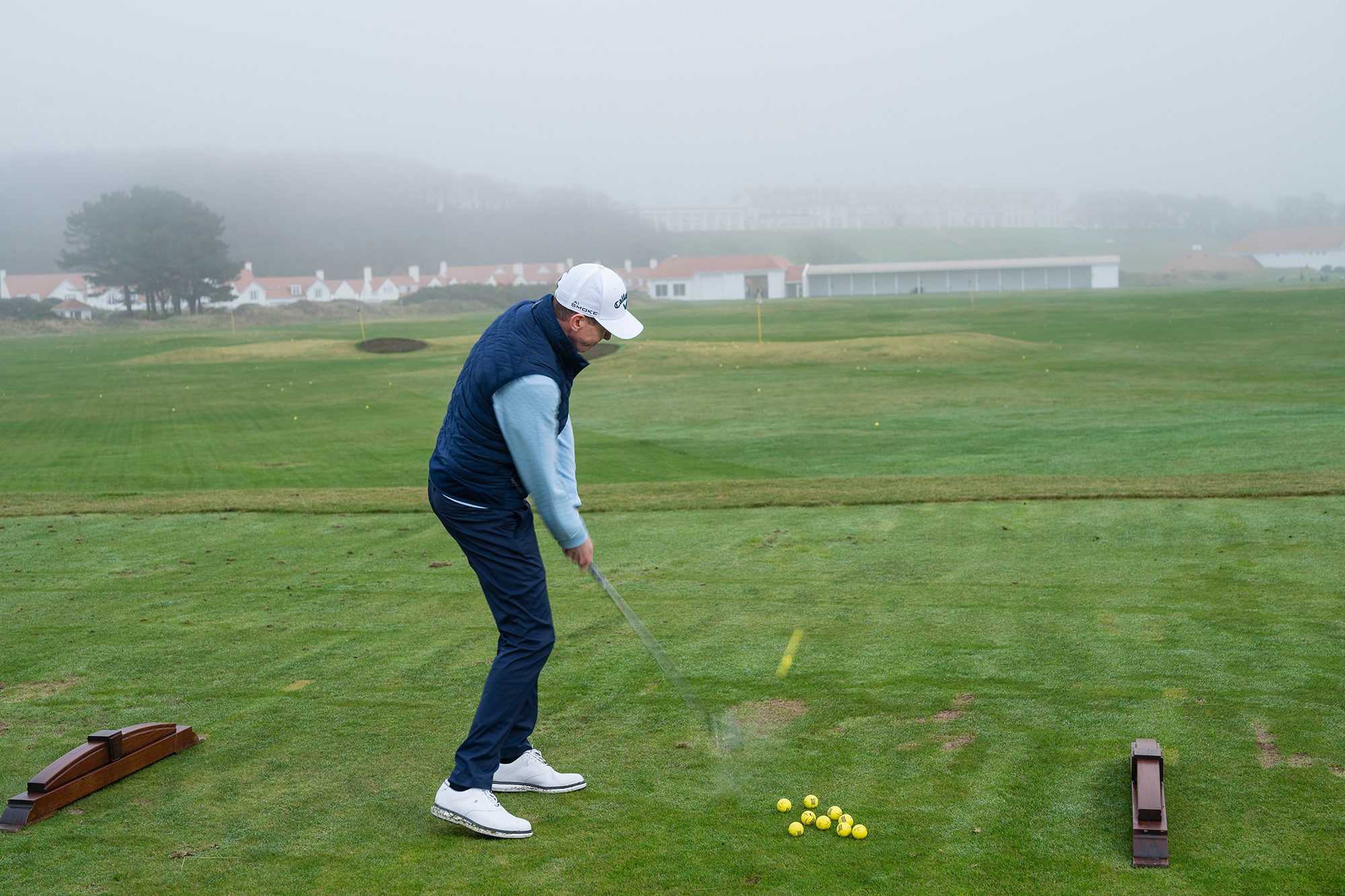 Ben Emerson &#039;machine-gunning&#039; through golf balls, which is a common amateur mistake, on the driving range at Trump Turnberry