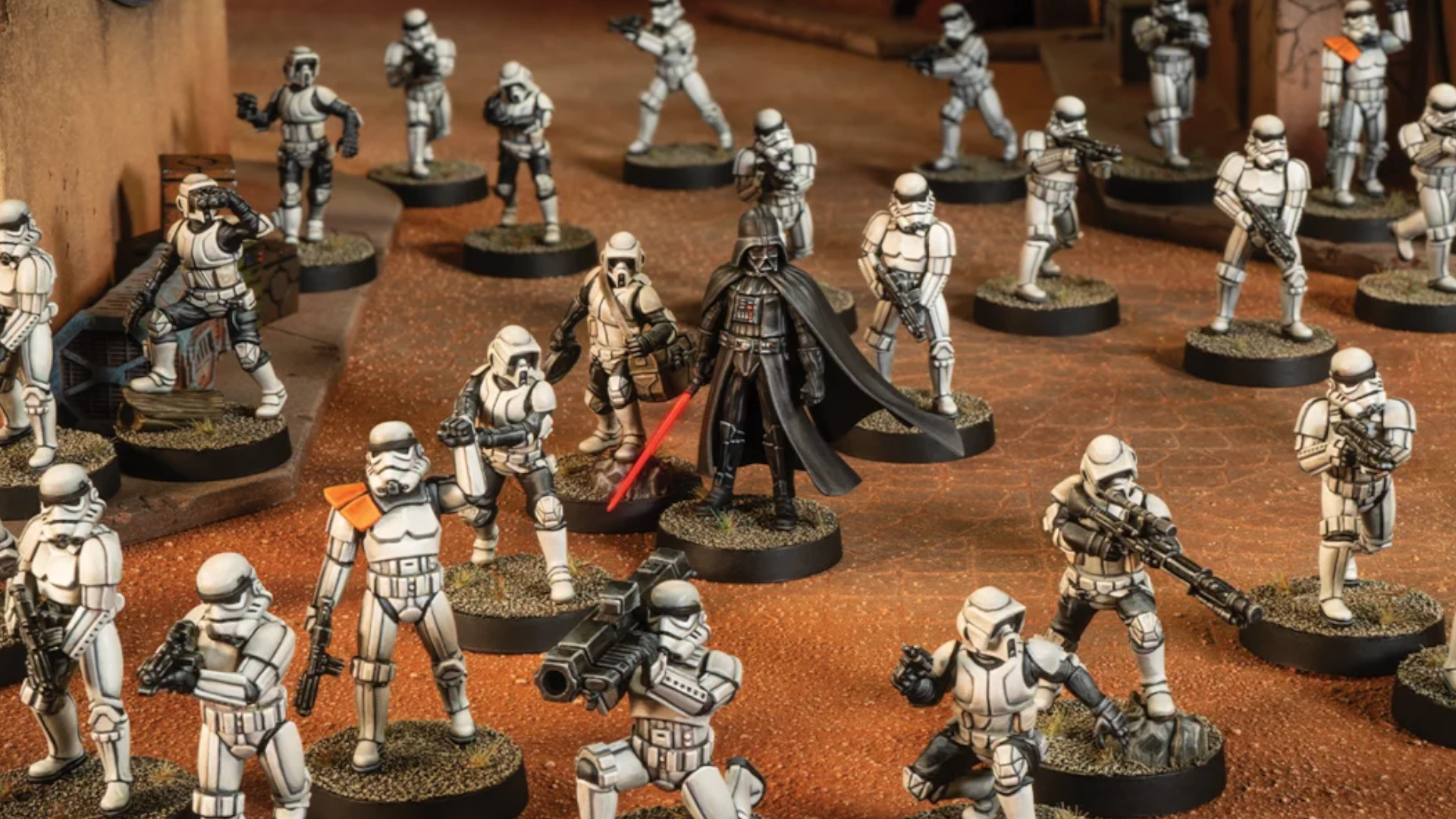 Darth Vader model surrounded by Stormtrooper miniatures on a desert battlefield