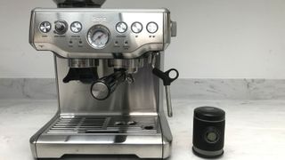 Wacaco Picopresso next to a Breville espresso machine