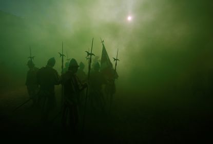 A historical parade arrives just before the 2017 Calcio Fiorentino semifinal match in Florence, Italy.