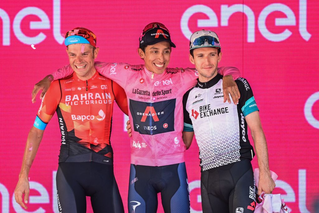 From L Secondplaced Team Bahrain rider Italys Damiano Caruso Giro dItalia 2021 winner Team Ineos rider Colombias Egan Bernal and thirdplaced Team BikeExchange rider Great Britains Simon Yates celebrates on the podium after the 21st and last stage on May 30 2021 in Milan Photo by MIGUEL MEDINA AFP Photo by MIGUEL MEDINAAFP via Getty Images
