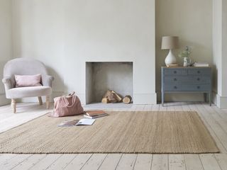 A living room with natural jute rug on a hardwood floor