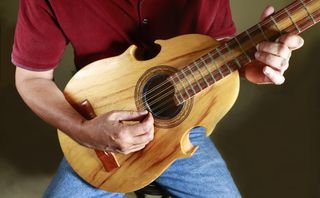 A cuatro is a stringed instrument adapted from the guitar. It originally had four strings but now has five sets of double strings.