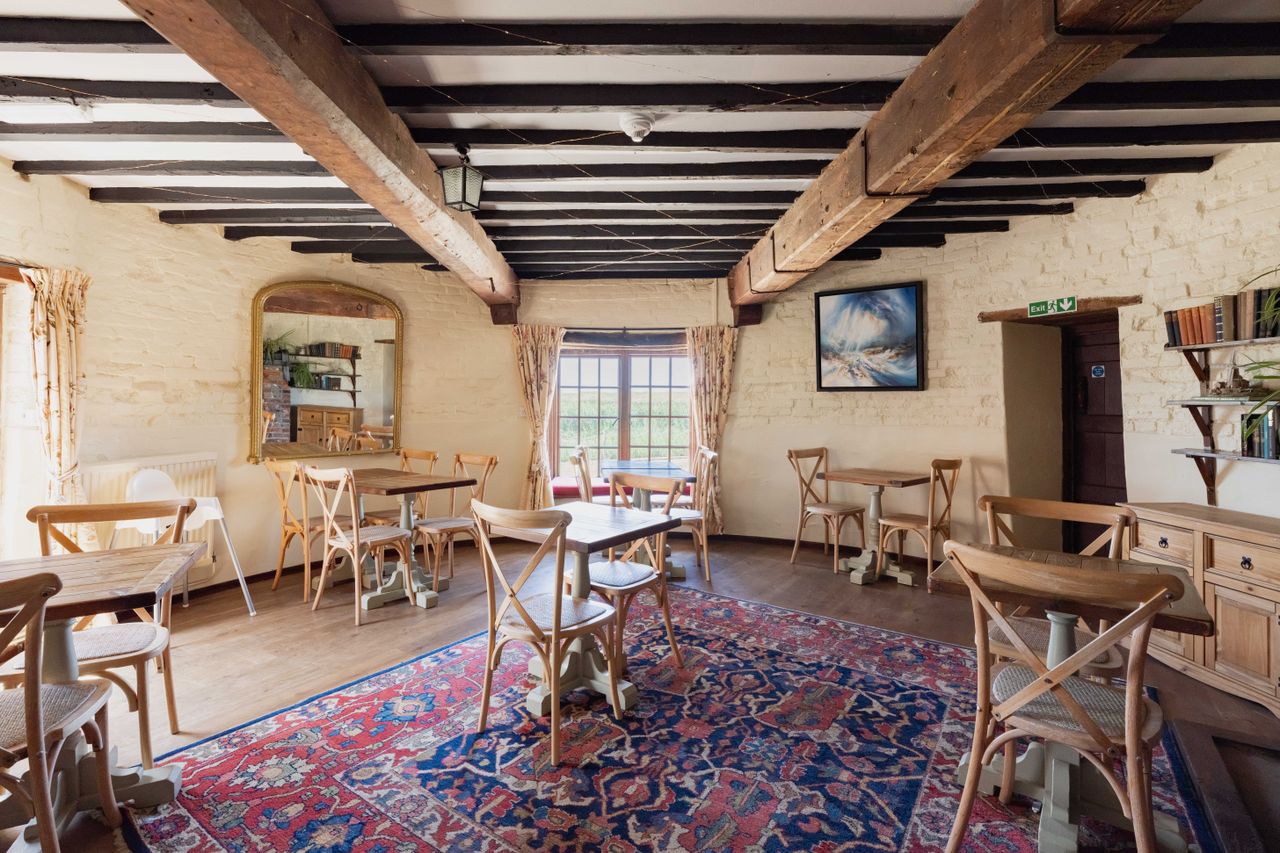 Cley Windmill. The mill is surrounded by reed beds and little rivers, and it is red brick with a white top. Inside, the rooms are luxurious but rustic, with lots of brick and exposed beams.