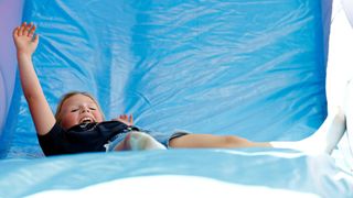 Mia Tindall plays going down a bouncy slide