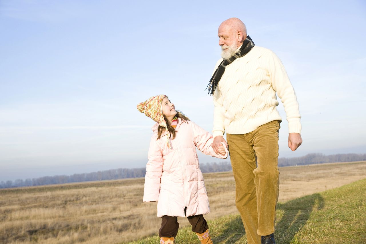 Grandparent holding hands with grandchild 