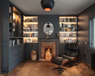 Dark grey black walls in cozy living room with Eames chair by Katie Malik Studio