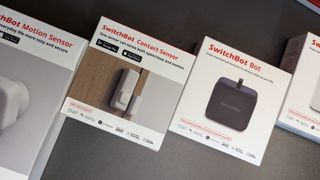 SwitchBot smart home products in boxes on a table