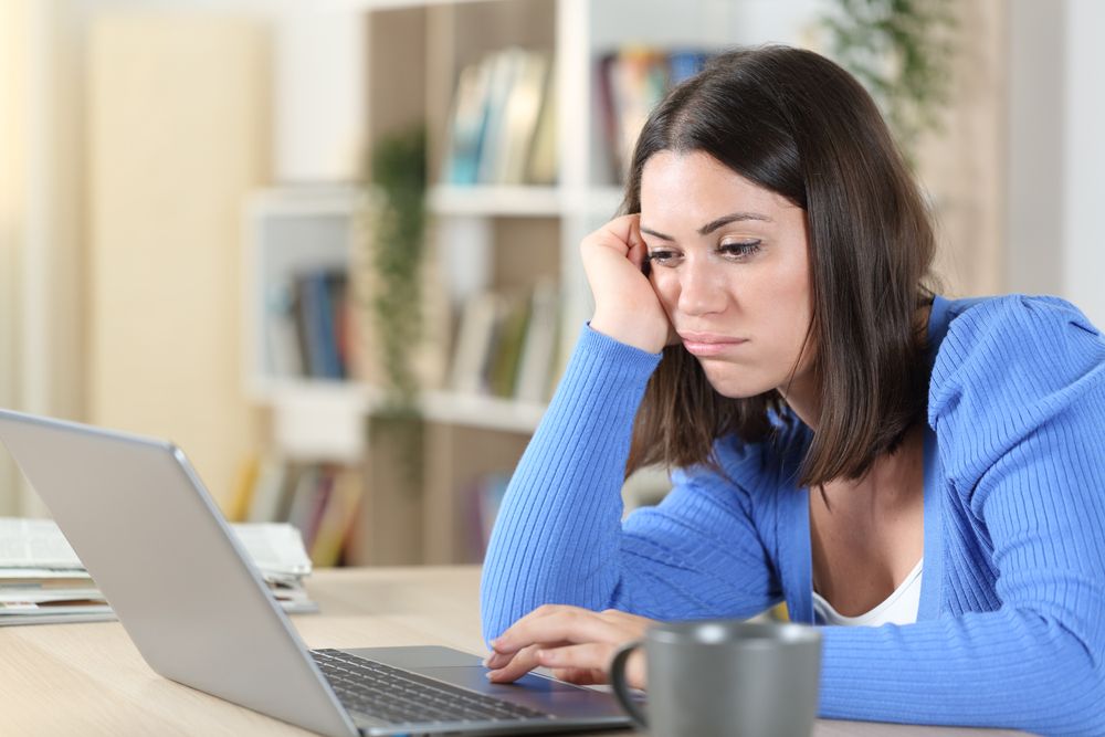 A woman who looks bored on a video call