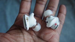 the anker soundcore liberty 3 pro wireless earbuds in someone's palm