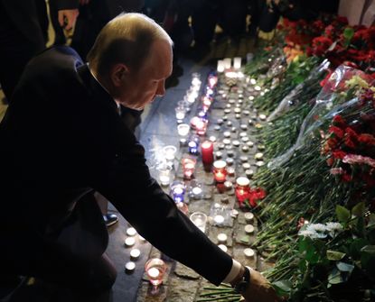 Russian President Vladimir Putin visits a memorial in St. Petersburg