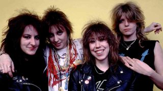 The band Girlschool against a yellow background