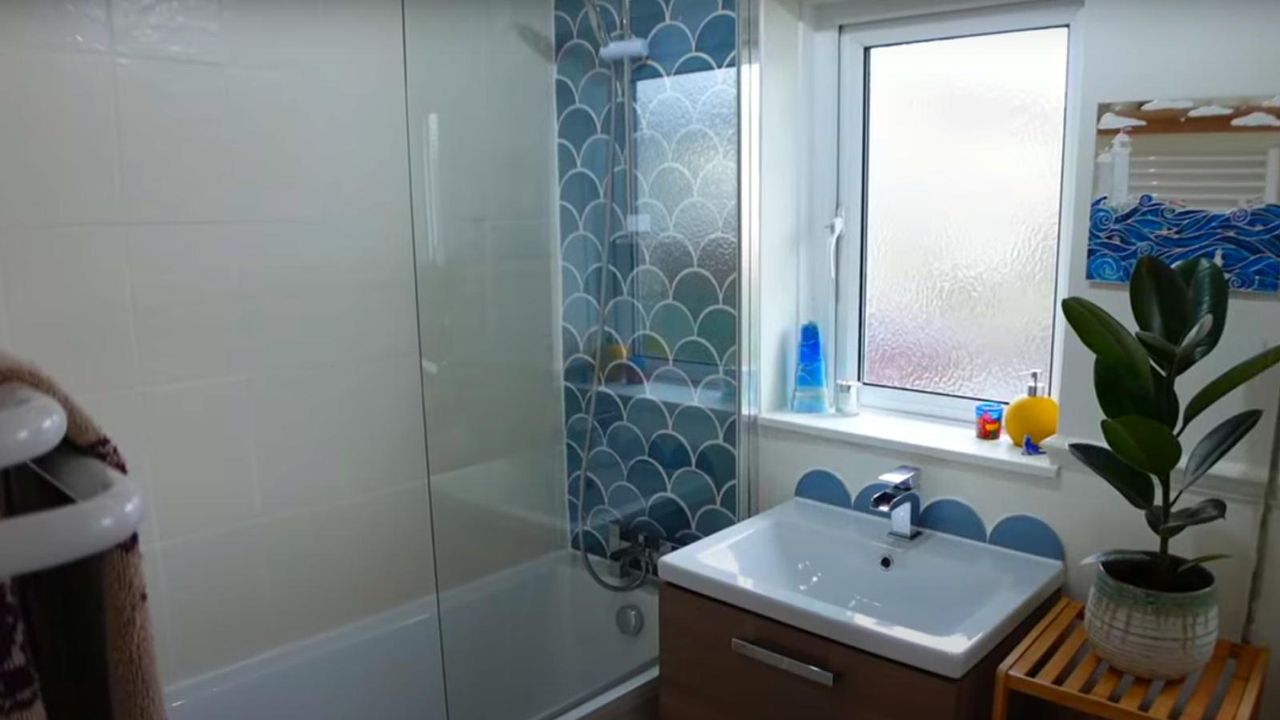 bathroom with blue fish scale tiles and shower bath