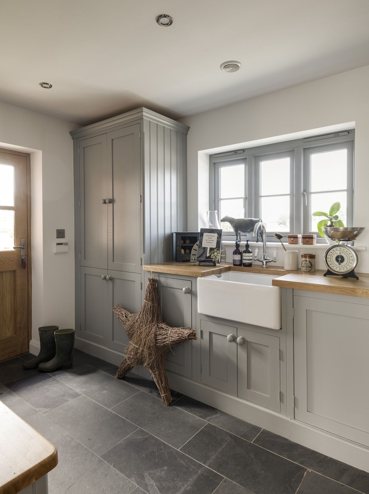 grey utility boot room with back door