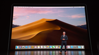 Apple CEO Tim Cook standing in front of a MacBook Air display at a special event in Brooklyn, New York