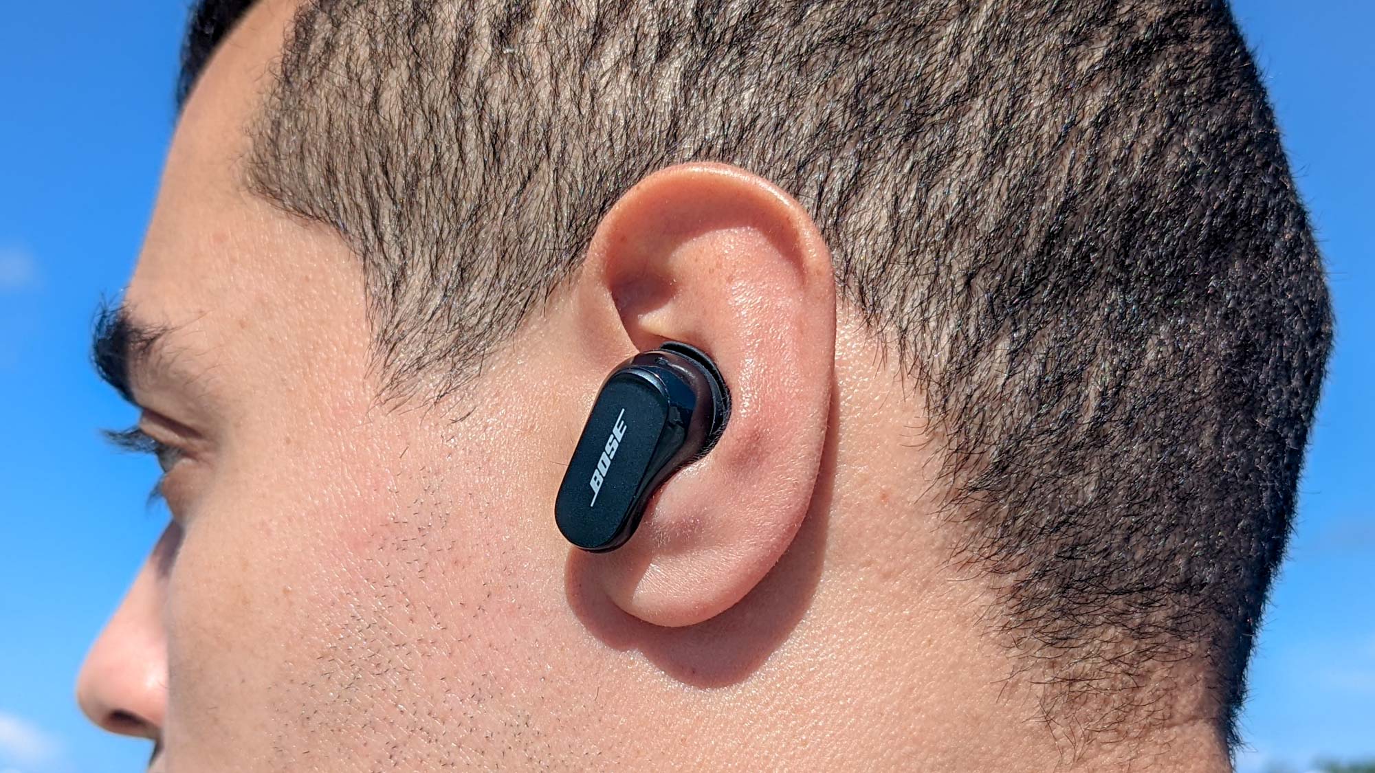 Close up image with side profile of reviewer wearing Bose QuietComfort Earbuds 2