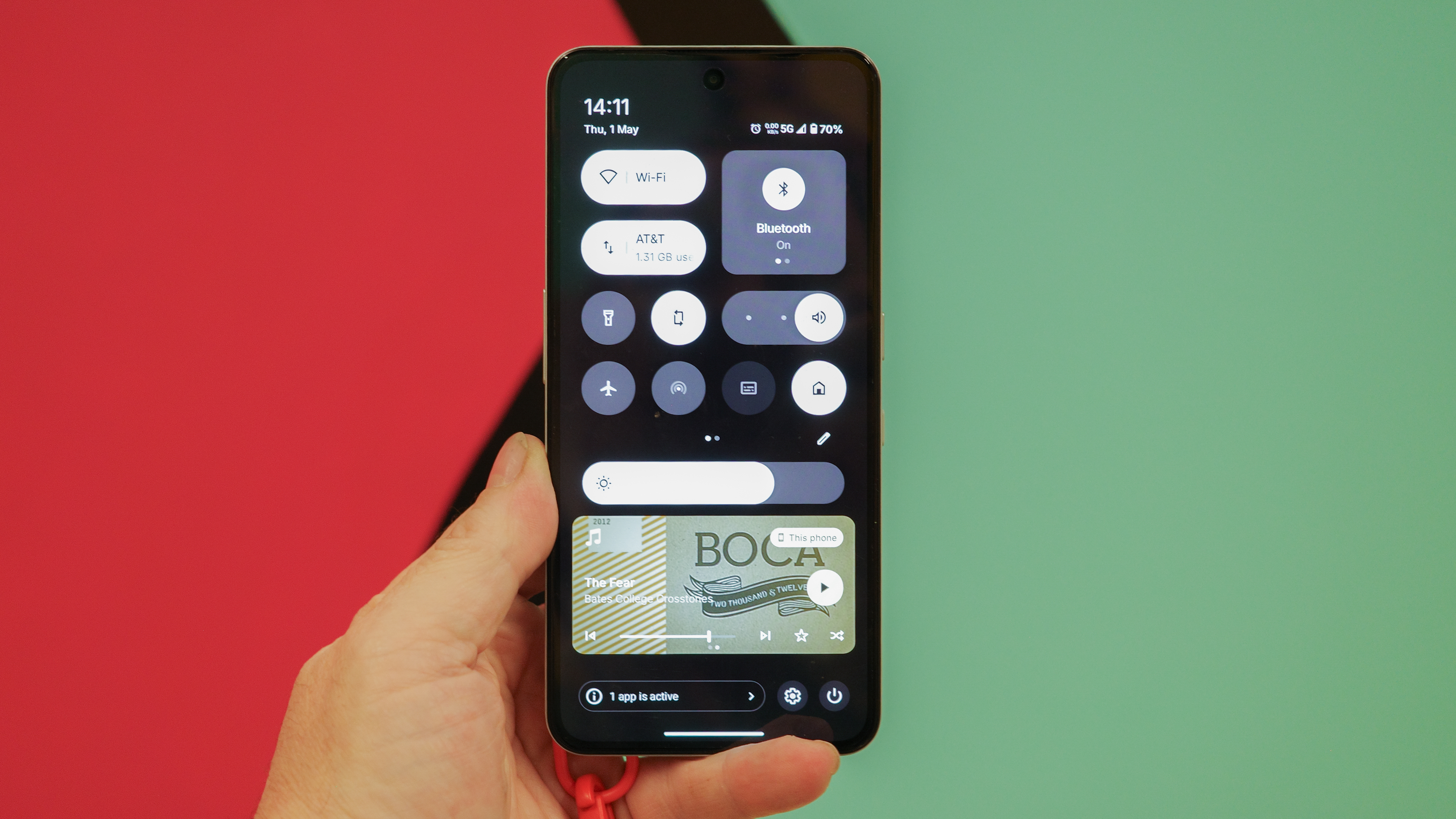 CMF Phone 2 Pro in hand with screen showing settings and widgets