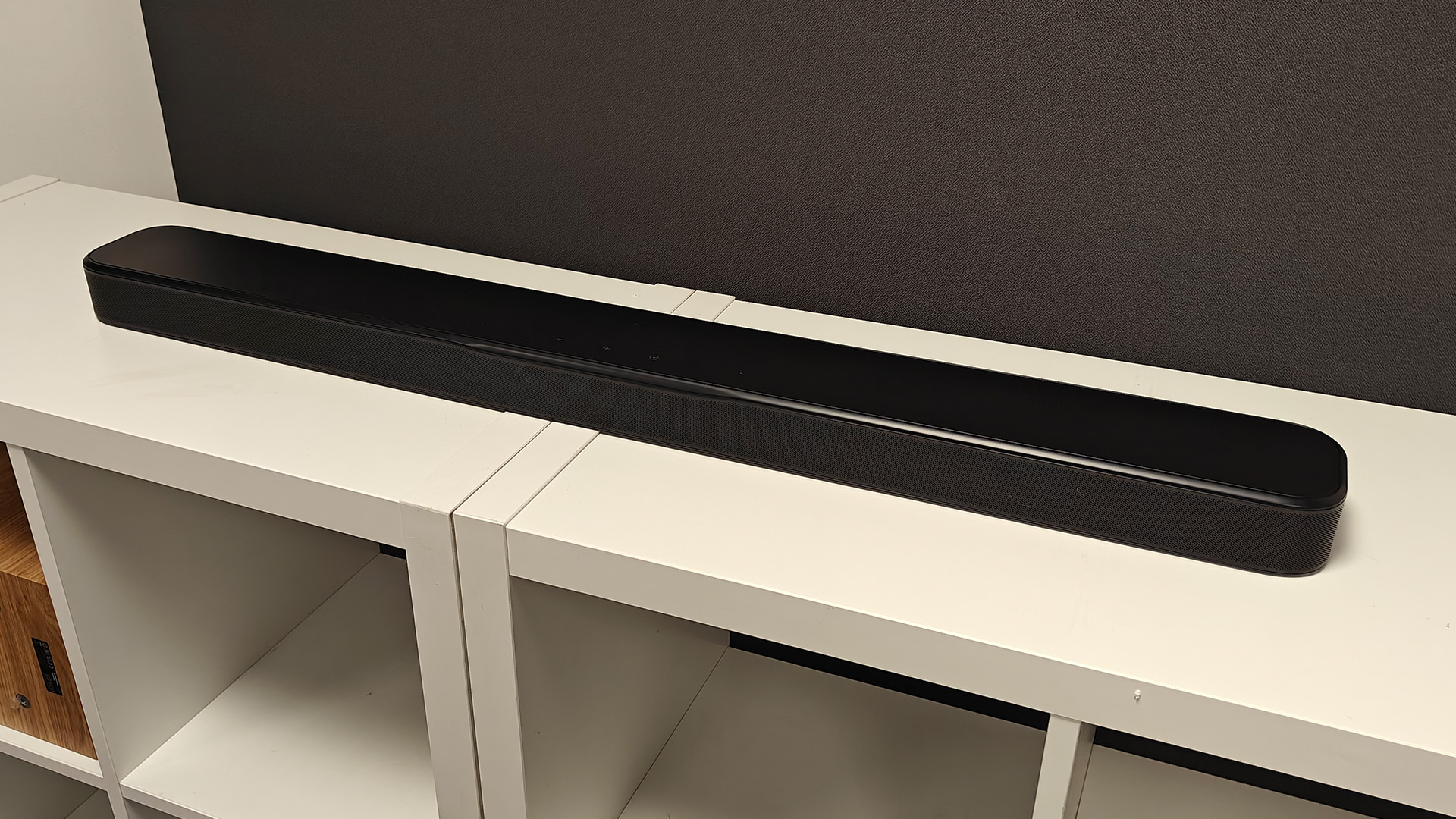 JBL Bar 300MK2 Dolby Atmos soundbar on white wooden shelves