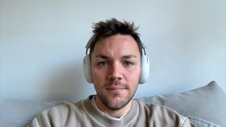 Sonos Ace headphones in soft white being worn on head