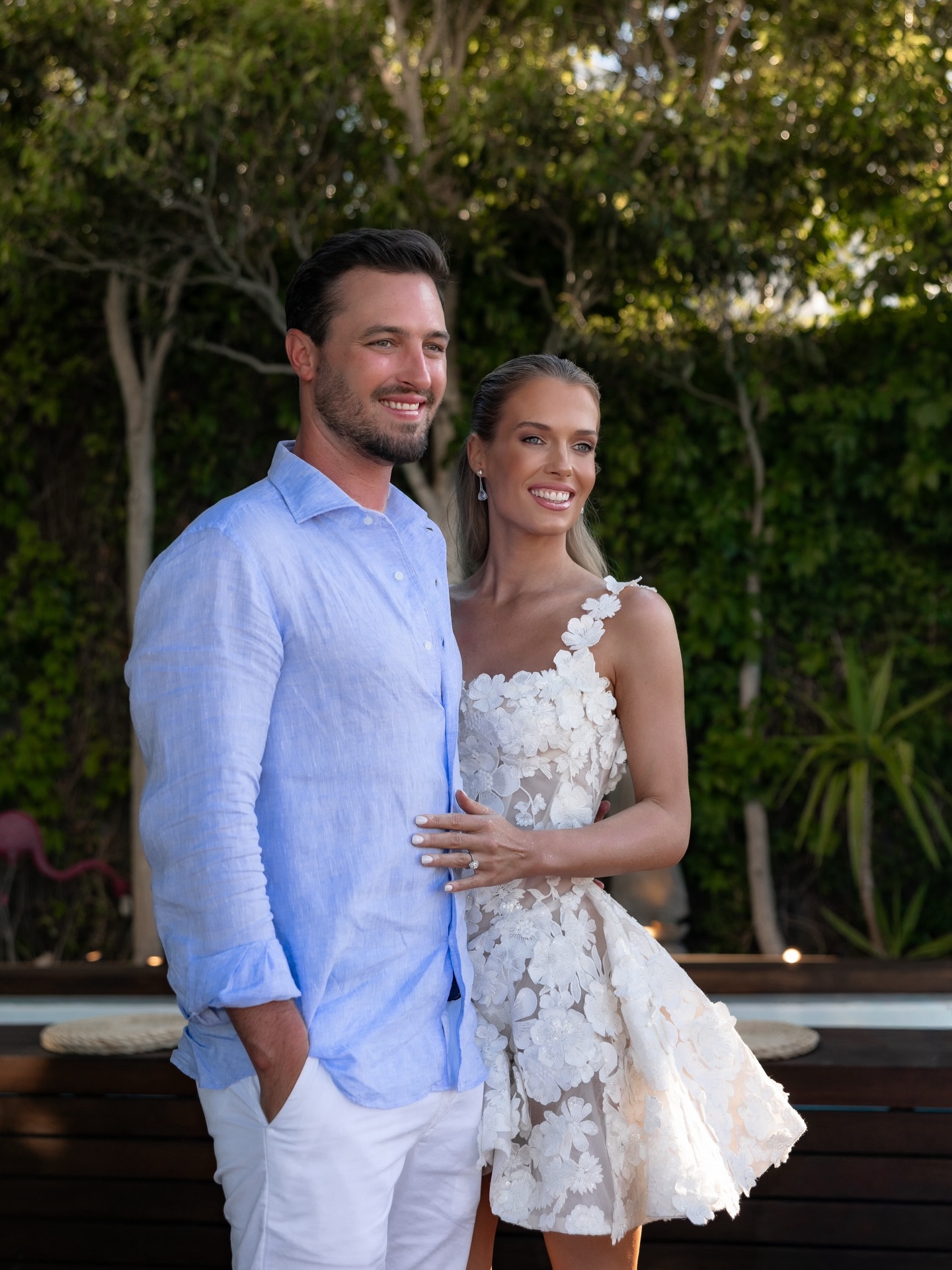 Channing Millerd wearing a blue shirt posing with Eliza Spencer in a white lace dress