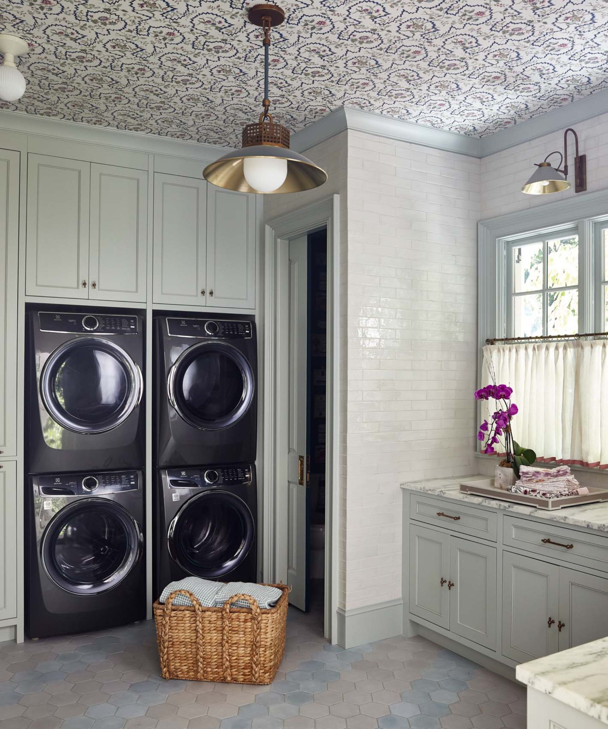 L.B Copeland laundry room with fitted cabinets, linen cupboard and a wallpapered ceiling