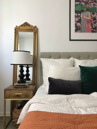 Grey bedroom with gold mirror