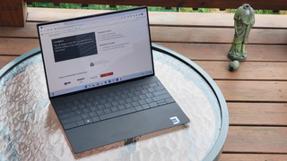 The Dell XPS 13 Plus on a patio table