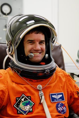 Mission Specialist Rex Walheim is eager to finish suiting up for launch of space shuttle Atlantis on the STS-122 mission.