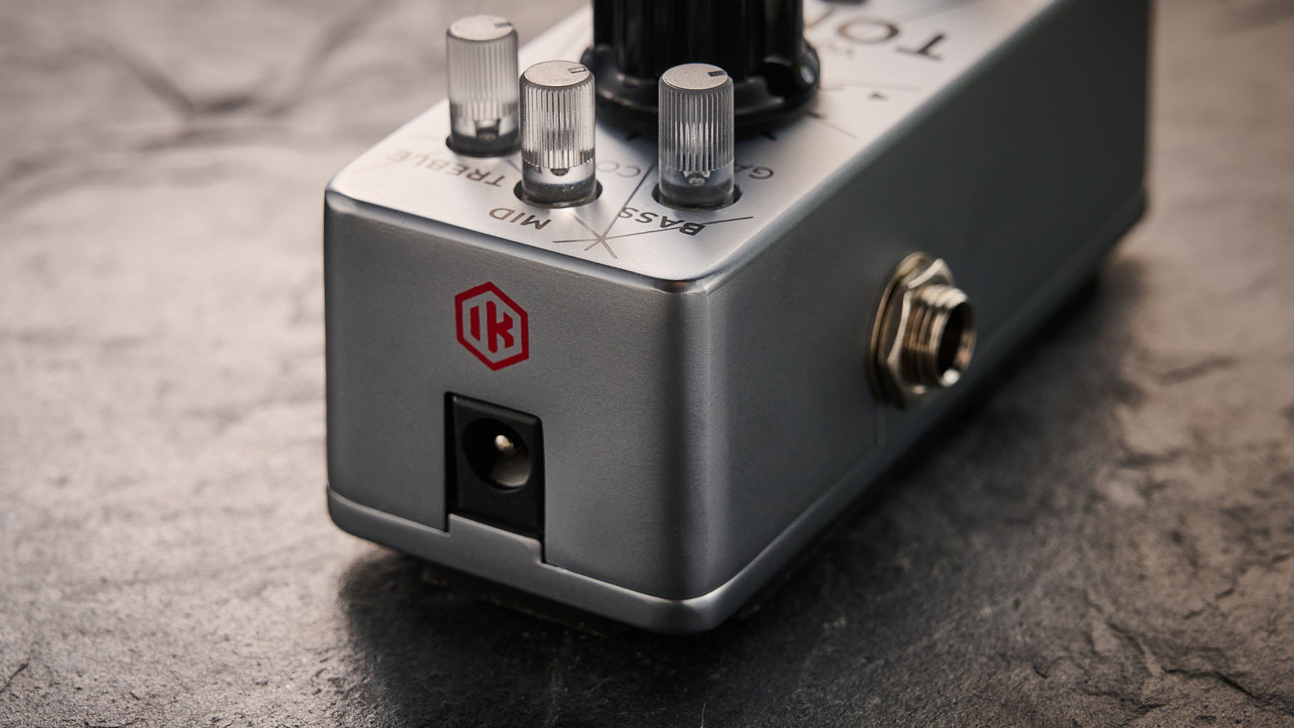 IK Multimedia Tonex One Bass: the mini-pedal offers amp modelling and heaps of tone options and is here photographed against a slate floor.