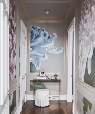 A hallway with pale mauve walls, painted with large blue and pink chrysanthemums