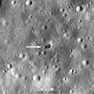 A satellite view of the moon showing twin craters where a rocket crashed in 2022