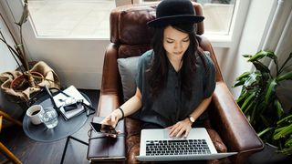 best free blogging platforms: a young woman writing a blog on a laptop