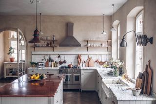 modern kitchen with marble worktop and rustic plaster walls