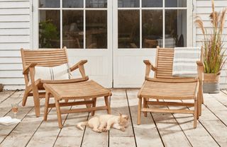 A pair of wooden lounge chairs