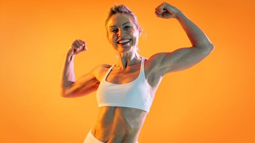 a woman flexing her biceps and smiling