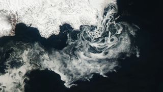 A close-up aerial shot of the swirling ice on the water.
