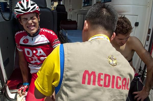 Adam Phelan (Drapac Cycling), currently second on the GC, receives treatment from the race doctor after crashing heavily on the run into the finish in Melaka.